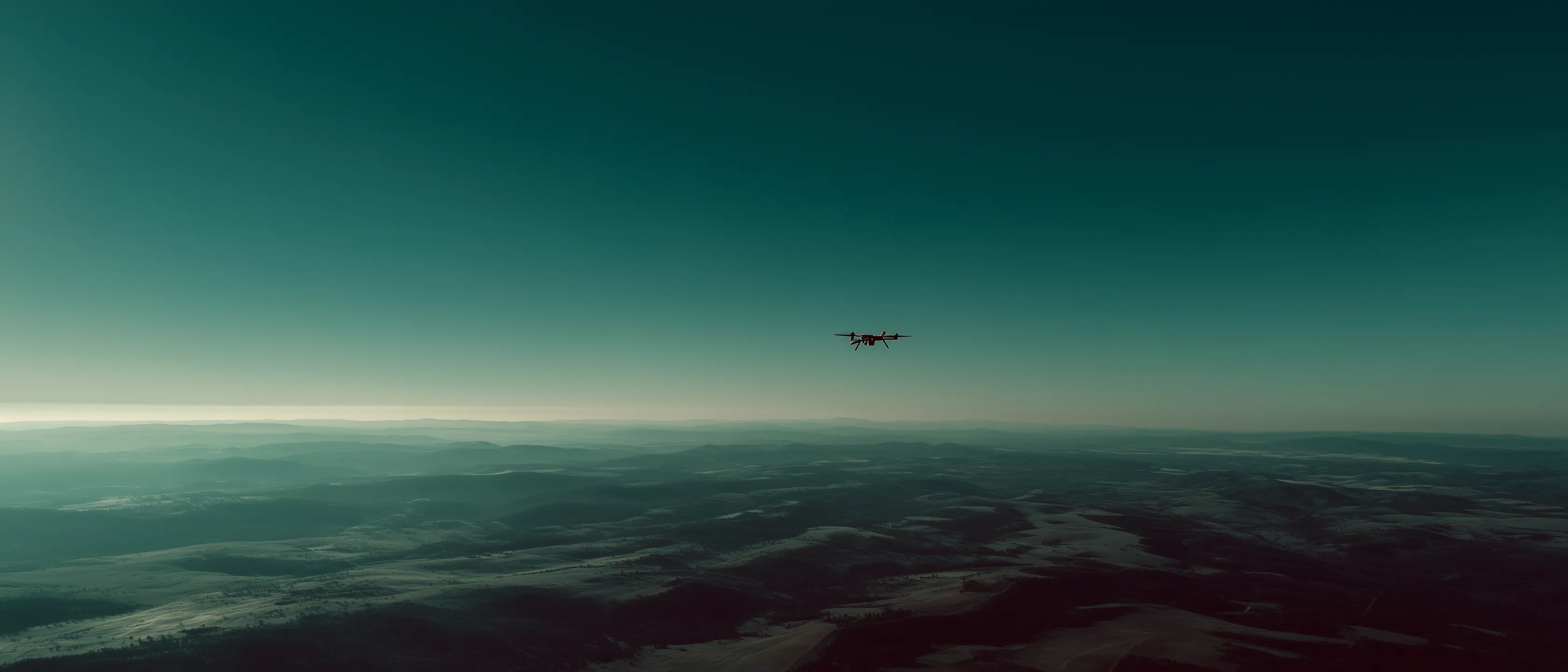 An EnCor UAS conducting aerial operations over open terrain.